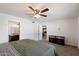 Spacious bedroom with ceiling fan, carpeted floor, en suite bathroom and backyard access at 4613 S Rita Ln, Tempe, AZ 85282
