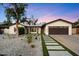Charming home with a dark garage door, desert landscaping, and concrete walkway at 4613 S Rita Ln, Tempe, AZ 85282