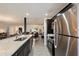 Open-concept kitchen with granite island flowing into living space, stainless appliances, and wood floors at 4613 S Rita Ln, Tempe, AZ 85282