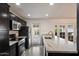 Charming kitchen featuring dark cabinets, stainless steel appliances, and a large island with granite countertop at 4613 S Rita Ln, Tempe, AZ 85282