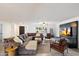 Bright living room with a large sectional sofa, wood floors, and large TV at 4613 S Rita Ln, Tempe, AZ 85282