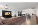 Open-concept living room and kitchen featuring wood floors and a large TV at 4613 S Rita Ln, Tempe, AZ 85282