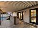 Covered patio with bar area, seamless access to the indoor kitchen, and views of the inviting backyard pool at 4613 S Rita Ln, Tempe, AZ 85282