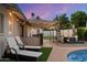 Relaxing pool area with comfortable lounge seating, bar area, outdoor kitchen, and manicured artificial turf at 4613 S Rita Ln, Tempe, AZ 85282