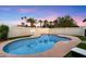 Inviting backyard pool featuring a basketball hoop, palm trees, and a privacy fence for leisure and entertainment at 4613 S Rita Ln, Tempe, AZ 85282