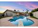 Backyard pool at dusk with diving board, outdoor bar, and patio seating under the warm glow of string lights at 4613 S Rita Ln, Tempe, AZ 85282