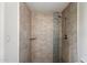 Modern shower with stone tile and glass accent, perfect for a relaxing experience at 4613 S Rita Ln, Tempe, AZ 85282