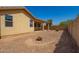 Desert backyard with a covered patio and natural landscaping elements at 5312 S 33Rd Ave, Phoenix, AZ 85041