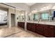 Large primary bathroom with dual sinks, large mirrors, and tiled floors at 5312 S 33Rd Ave, Phoenix, AZ 85041