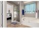 The bathroom features a glass shower and soaking tub at 5312 S 33Rd Ave, Phoenix, AZ 85041