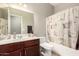 Well-lit bathroom with a vanity, framed mirror, and bathtub with shower at 5312 S 33Rd Ave, Phoenix, AZ 85041