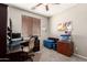 Comfortable bedroom featuring a functional desk area and ceiling fan at 5312 S 33Rd Ave, Phoenix, AZ 85041