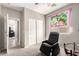 Bedroom featuring a black massage chair, sliding door closet, and ceiling fan at 5312 S 33Rd Ave, Phoenix, AZ 85041