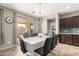 Bright dining room features chandelier, sliding door access to patio, and tiled floors at 5312 S 33Rd Ave, Phoenix, AZ 85041