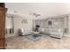 A spacious living room features tile flooring, neutral colors and comfortable seating at 5312 S 33Rd Ave, Phoenix, AZ 85041