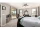 Large main bedroom features a ceiling fan, carpet floors, and sliding door access to backyard at 5312 S 33Rd Ave, Phoenix, AZ 85041