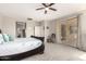 The main bedroom includes a ceiling fan, carpet floors, and sliding door access to backyard at 5312 S 33Rd Ave, Phoenix, AZ 85041