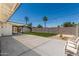Large backyard features concrete patio, seating area, artificial turf, and covered patio at 554 N Sunset Dr, Chandler, AZ 85225