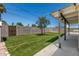 This backyard showcases a well-kept lawn, block wall, and covered patio area at 554 N Sunset Dr, Chandler, AZ 85225