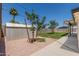 Backyard has a gravel area and a patch of grass with small trees in a sunny yard at 554 N Sunset Dr, Chandler, AZ 85225