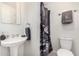 Cozy bathroom features a pedestal sink, modern fixtures and neutral colors at 554 N Sunset Dr, Chandler, AZ 85225