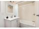 Bright bathroom featuring a white vanity with tub and shower combination at 554 N Sunset Dr, Chandler, AZ 85225