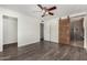 A spacious bedroom features wood-look floors, a closet and a view of the bathroom at 554 N Sunset Dr, Chandler, AZ 85225
