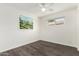 Bedroom with modern ceiling fan, wood-look floors, bright walls and a picture window at 554 N Sunset Dr, Chandler, AZ 85225