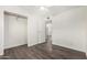 A bright bedroom features wood-look floors and a closet to organize and store your wardrobe at 554 N Sunset Dr, Chandler, AZ 85225