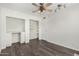 This bedroom offers a built-in desk, closet, and a ceiling fan at 554 N Sunset Dr, Chandler, AZ 85225