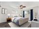 Stylized bedroom with luxury furniture, wood-look floors, and a stylish ceiling fan at 554 N Sunset Dr, Chandler, AZ 85225