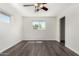 This bright bedroom features wood-look floors, neutral walls, a closet and a ceiling fan at 554 N Sunset Dr, Chandler, AZ 85225