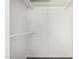 Walk-in closet with shelves and hanging rods for organizing clothes at 554 N Sunset Dr, Chandler, AZ 85225