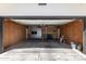 An open garage with plywood walls, concrete floor, shelving, storage, and back door at 554 N Sunset Dr, Chandler, AZ 85225
