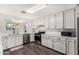 Bright kitchen features white cabinets, stainless steel appliances, and stylish countertops at 554 N Sunset Dr, Chandler, AZ 85225
