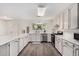 Updated kitchen with white cabinets, stainless steel appliances, and subway tile backsplash at 554 N Sunset Dr, Chandler, AZ 85225