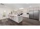 Bright kitchen features a center island with seating and stainless steel appliances at 554 N Sunset Dr, Chandler, AZ 85225