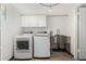 Well-equipped laundry room with modern washer, dryer, sink, and cabinets at 554 N Sunset Dr, Chandler, AZ 85225