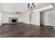 Spacious living area featuring a brick fireplace, ceiling fan, and dark wood flooring at 554 N Sunset Dr, Chandler, AZ 85225