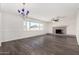 Spacious living room featuring sleek floors, a cozy fireplace, and tons of natural light at 554 N Sunset Dr, Chandler, AZ 85225