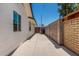 The side yard shows a concrete walkway, block wall, and access gate at 554 N Sunset Dr, Chandler, AZ 85225
