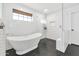 Bathroom with a stand alone tub, black hexagon tile floor, and a walk-in shower at 5612 E Emile Zola Ave, Scottsdale, AZ 85254