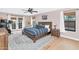 Bedroom with wood floors, a large window, french doors, and a wooden bed frame at 5612 E Emile Zola Ave, Scottsdale, AZ 85254