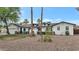 Beautifully renovated home featuring a white painted exterior, dark trim, and mature landscaping at 5612 E Emile Zola Ave, Scottsdale, AZ 85254