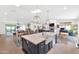Open-concept kitchen with expansive island featuring a farmhouse sink, stylish lighting, and connection to living areas at 5612 E Emile Zola Ave, Scottsdale, AZ 85254