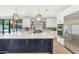 Gourmet kitchen with large center island, stainless steel appliances, and views of the backyard at 5612 E Emile Zola Ave, Scottsdale, AZ 85254