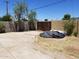 Backyard featuring a large concrete patio, cinderblock wall, and wooden gate at 6011 N 33Rd Ave, Phoenix, AZ 85017