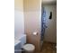 Modest bathroom featuring tiled walls, toilet, and shower with patterned curtain at 6011 N 33Rd Ave, Phoenix, AZ 85017