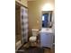 Bathroom with a shower/tub combination, toilet, and a blue vanity with sink and mirror at 6011 N 33Rd Ave, Phoenix, AZ 85017