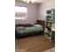 Well-lit bedroom with a comfy bed, window with blinds, and bright blue shelving at 6011 N 33Rd Ave, Phoenix, AZ 85017